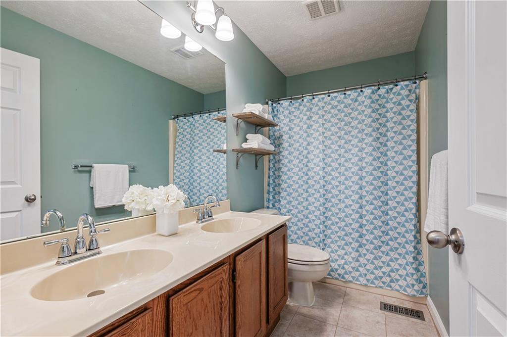 121 Tiffany Ridge Drive Coraopolis, PA 15108 - Photo 21 of 28 The full bath offers a double sink vanity and tile flooring.