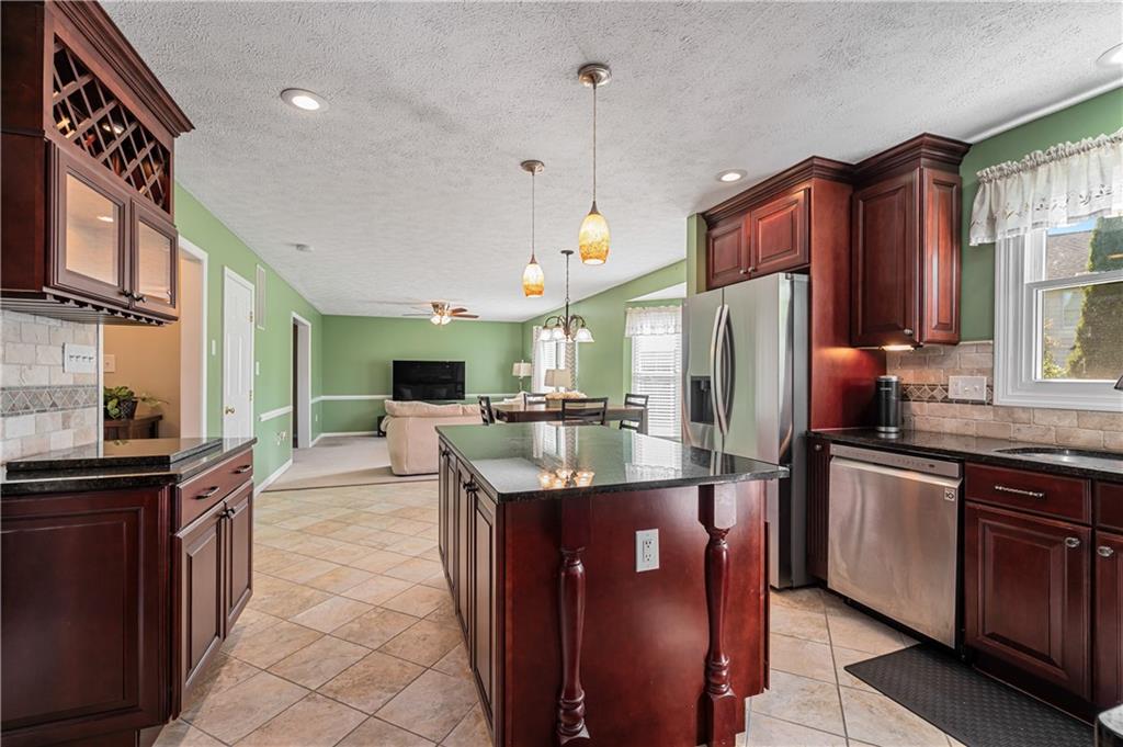 121 Tiffany Ridge Drive Coraopolis, PA 15108 - Photo 6 of 28 The kitchen opens into the family room creating a nice and open feel. Ceramic tile flooring and abundant cabinetry make this kitchen so desirable.