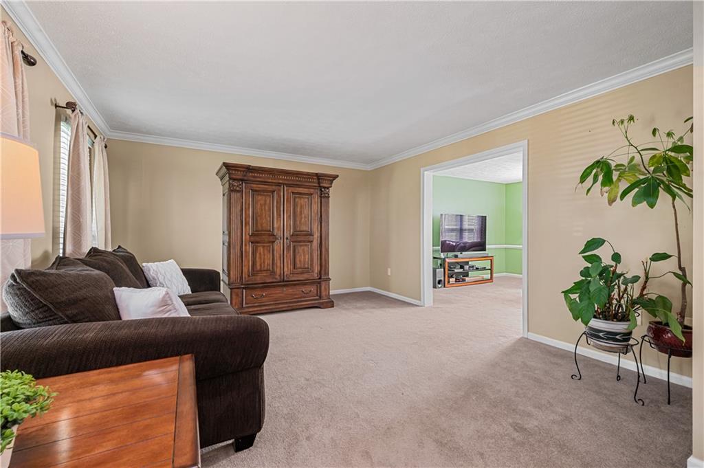 121 Tiffany Ridge Drive Coraopolis, PA 15108 - Photo 9 of 28 The formal living room includes crown molding and neutral décor.