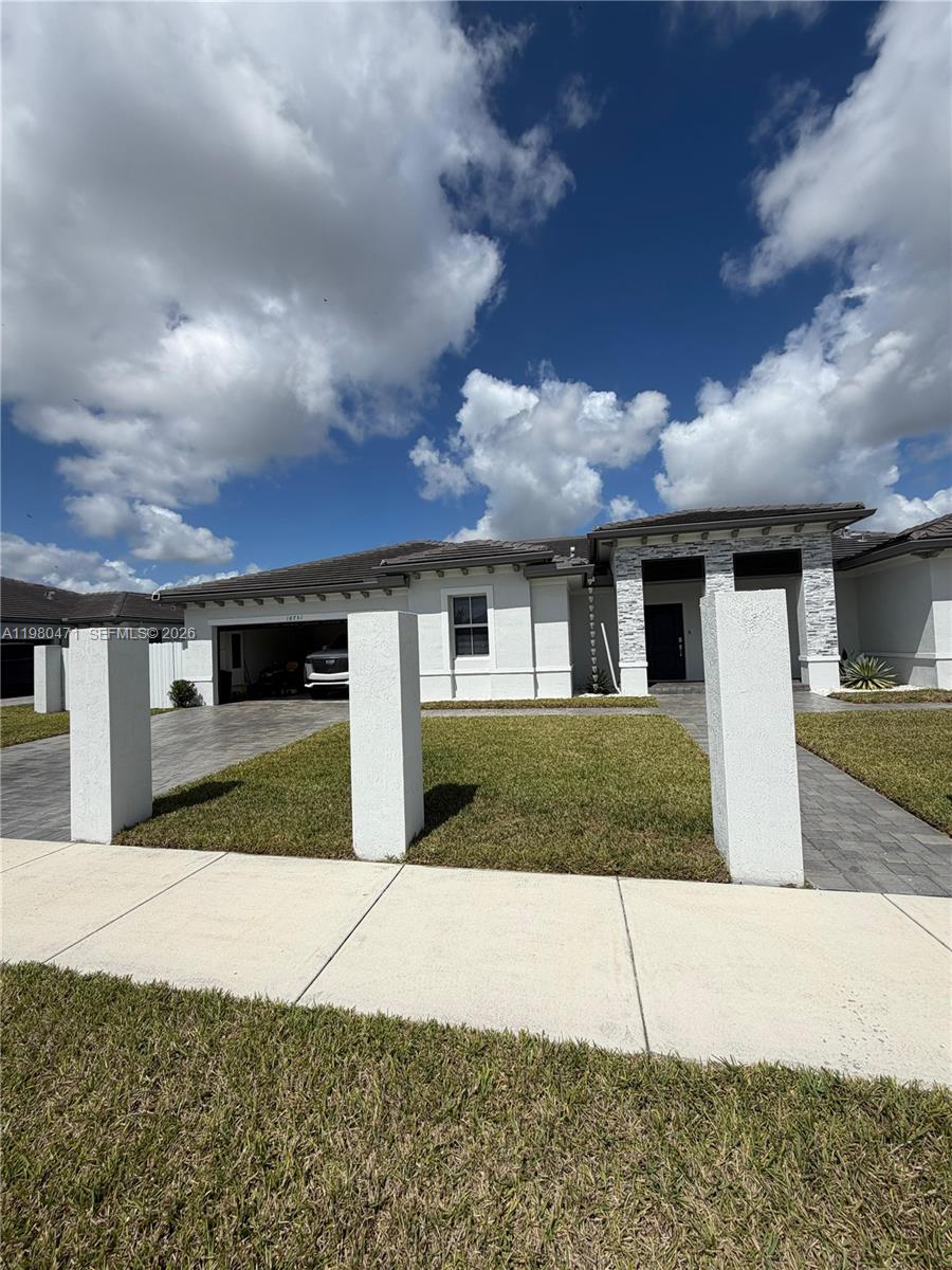 a front view of a house with a yard