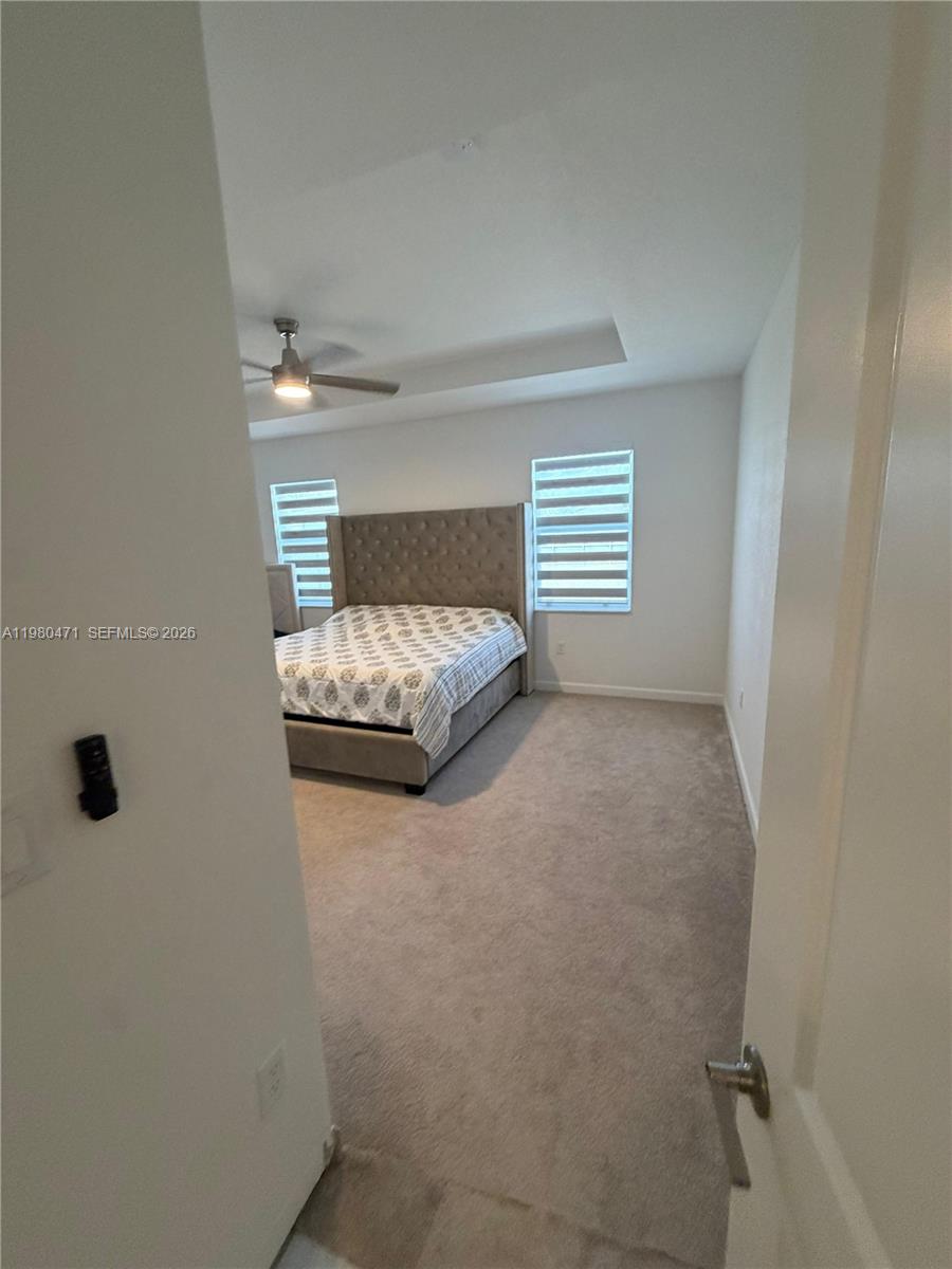 16751 Southwest 291st Terrace, Unit 16751 Homestead, FL 33030 - Photo 12 of 20 a bedroom with a bed and a window