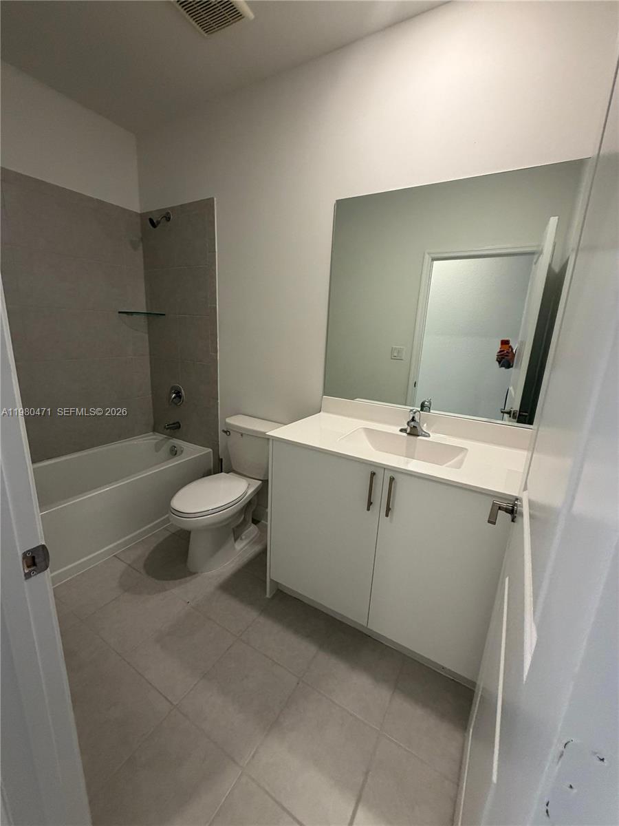 16751 Southwest 291st Terrace, Unit 16751 Homestead, FL 33030 - Photo 17 of 20 a bathroom with a sink a toilet and shower