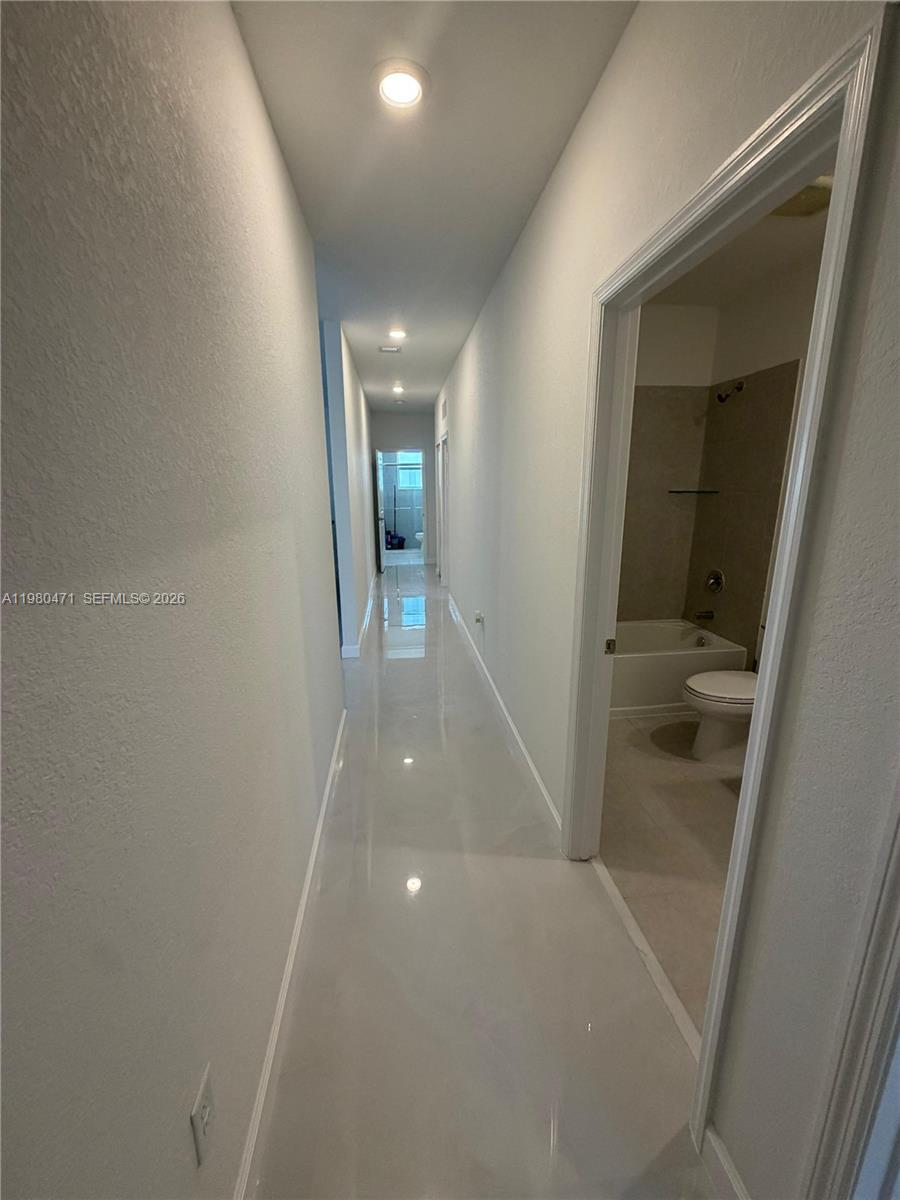 16751 Southwest 291st Terrace, Unit 16751 Homestead, FL 33030 - Photo 18 of 20 an entryway in a hall with a window