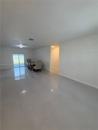 a view of an empty room and a window