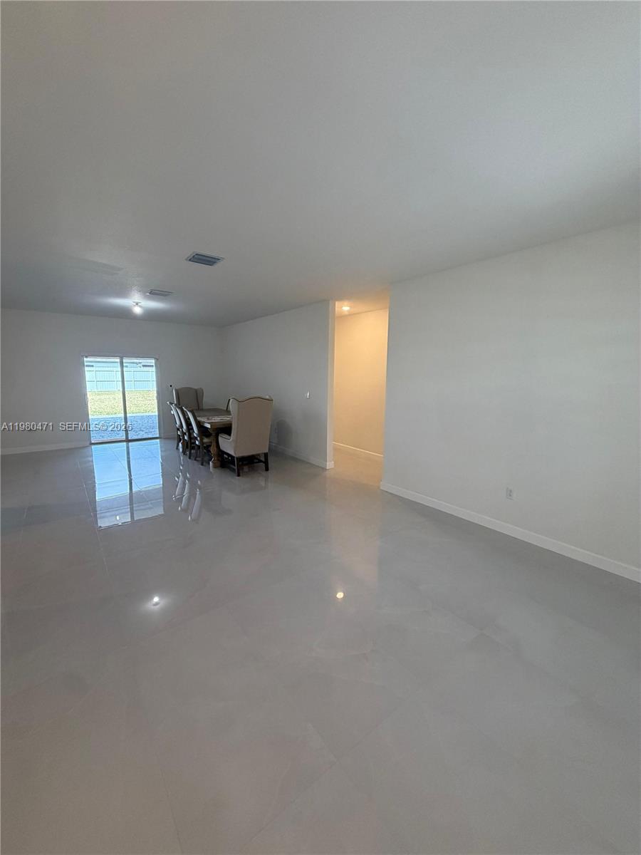 16751 Southwest 291st Terrace, Unit 16751 Homestead, FL 33030 - Photo 4 of 20 a view of an empty room and a window
