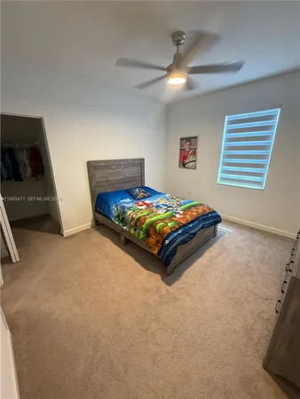 a bedroom with a bed and a tv on the dresser