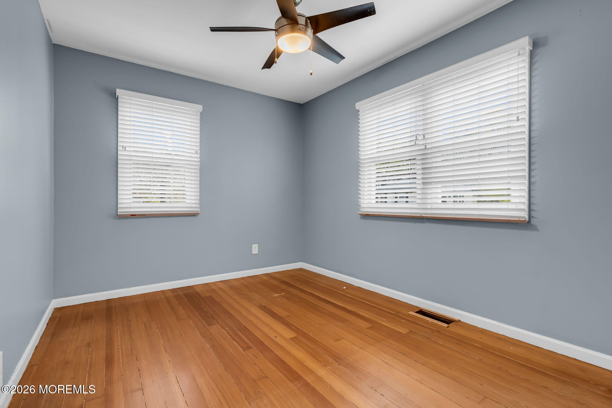 593 Beach Plum Road Brick, NJ 08723 - Photo 24 of 38 a view of an empty room with wooden floor and a window