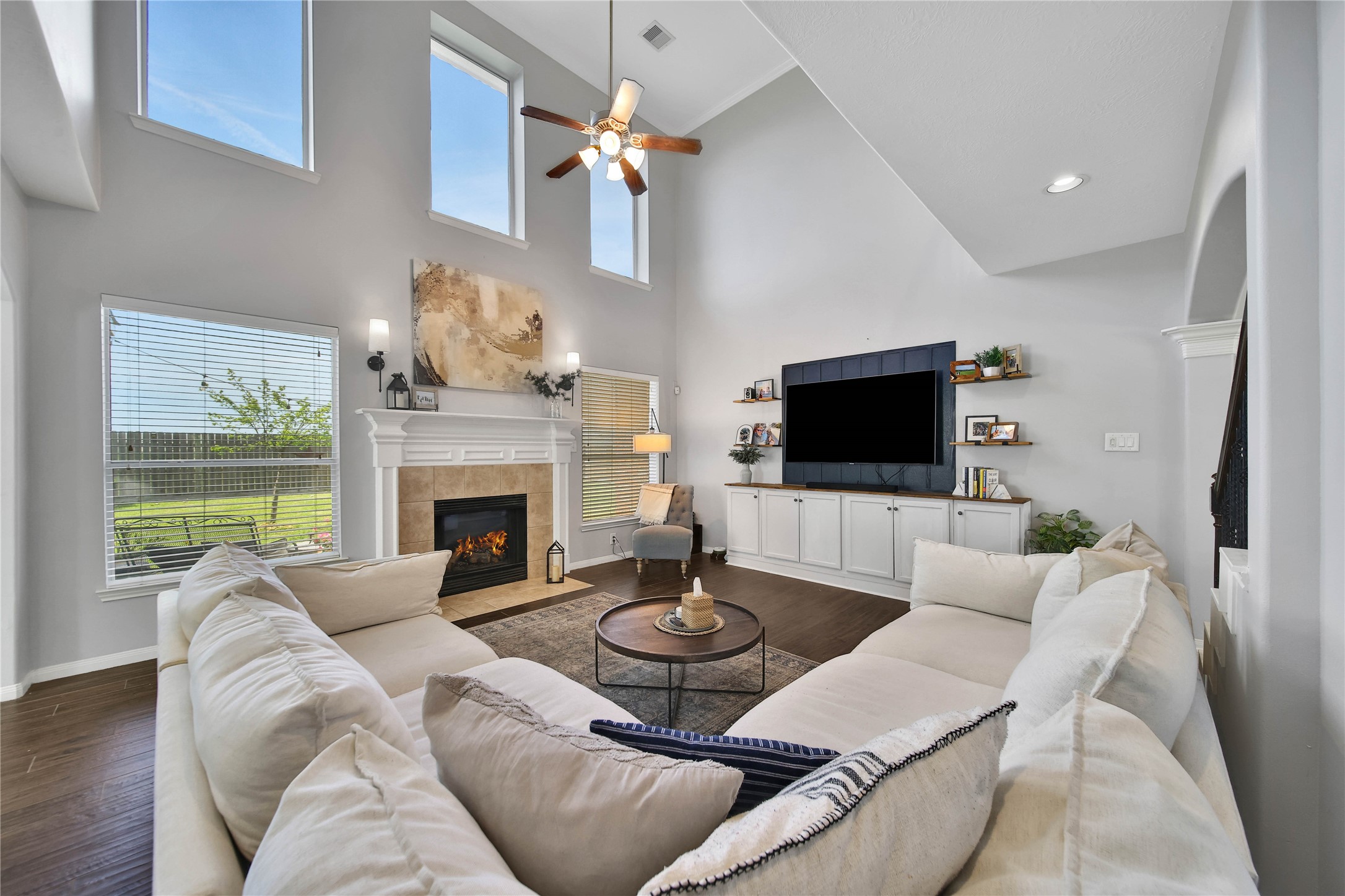 21715 Flecherwood Court Spring, TX 77388 - Photo 11 of 43 a living room with furniture a fireplace and a flat screen tv