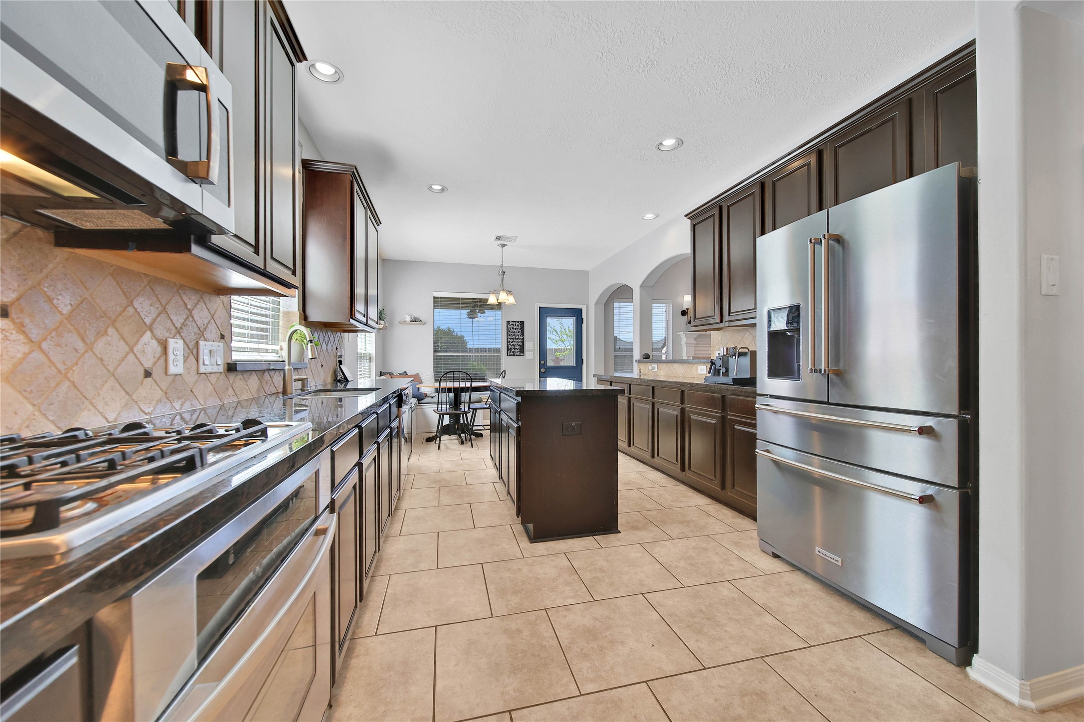 21715 Flecherwood Court Spring, TX 77388 - Photo 15 of 43 a kitchen with a stove a refrigerator and cabinets