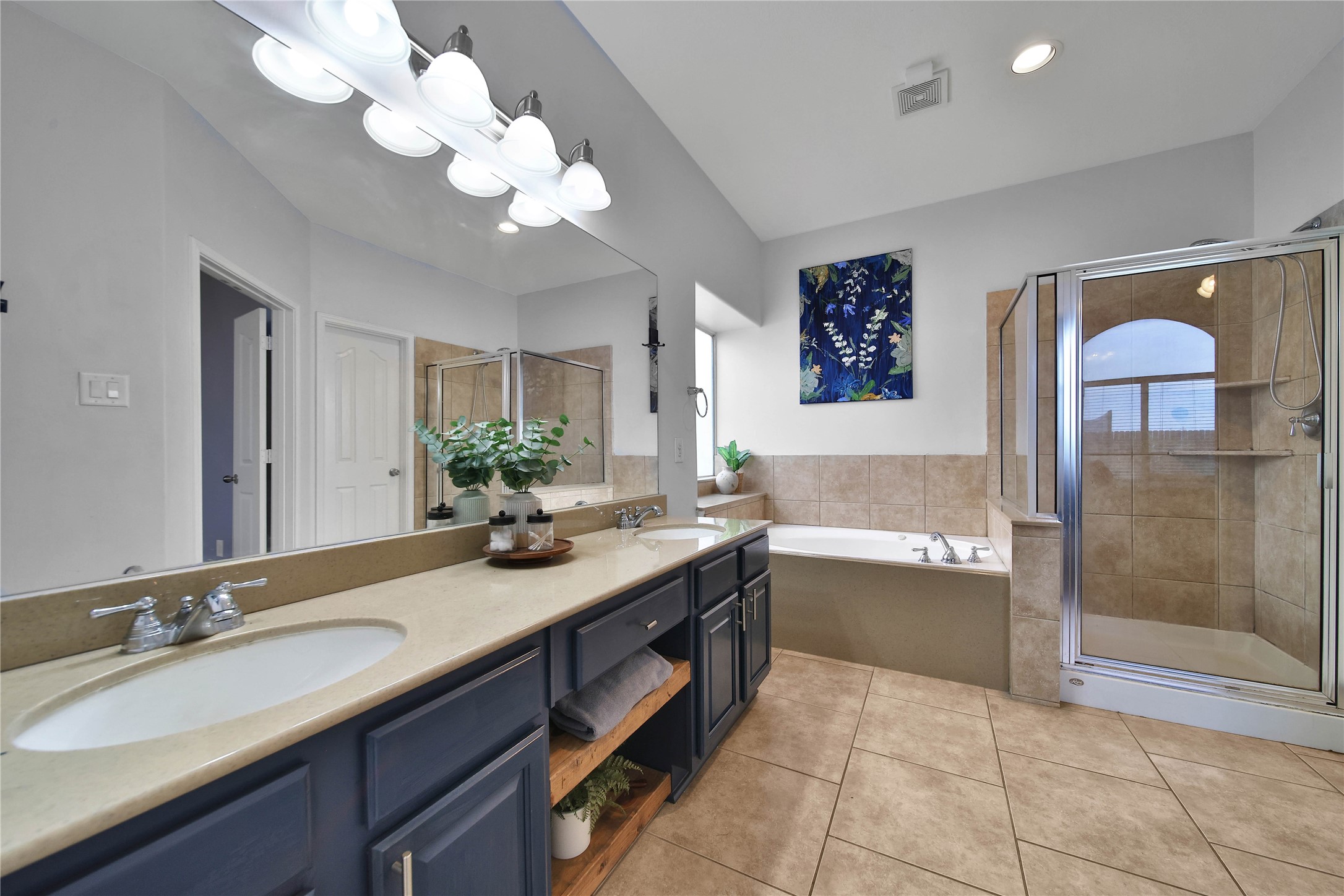 21715 Flecherwood Court Spring, TX 77388 - Photo 20 of 43 a bathroom with a granite countertop sink a large mirror and a bathtub