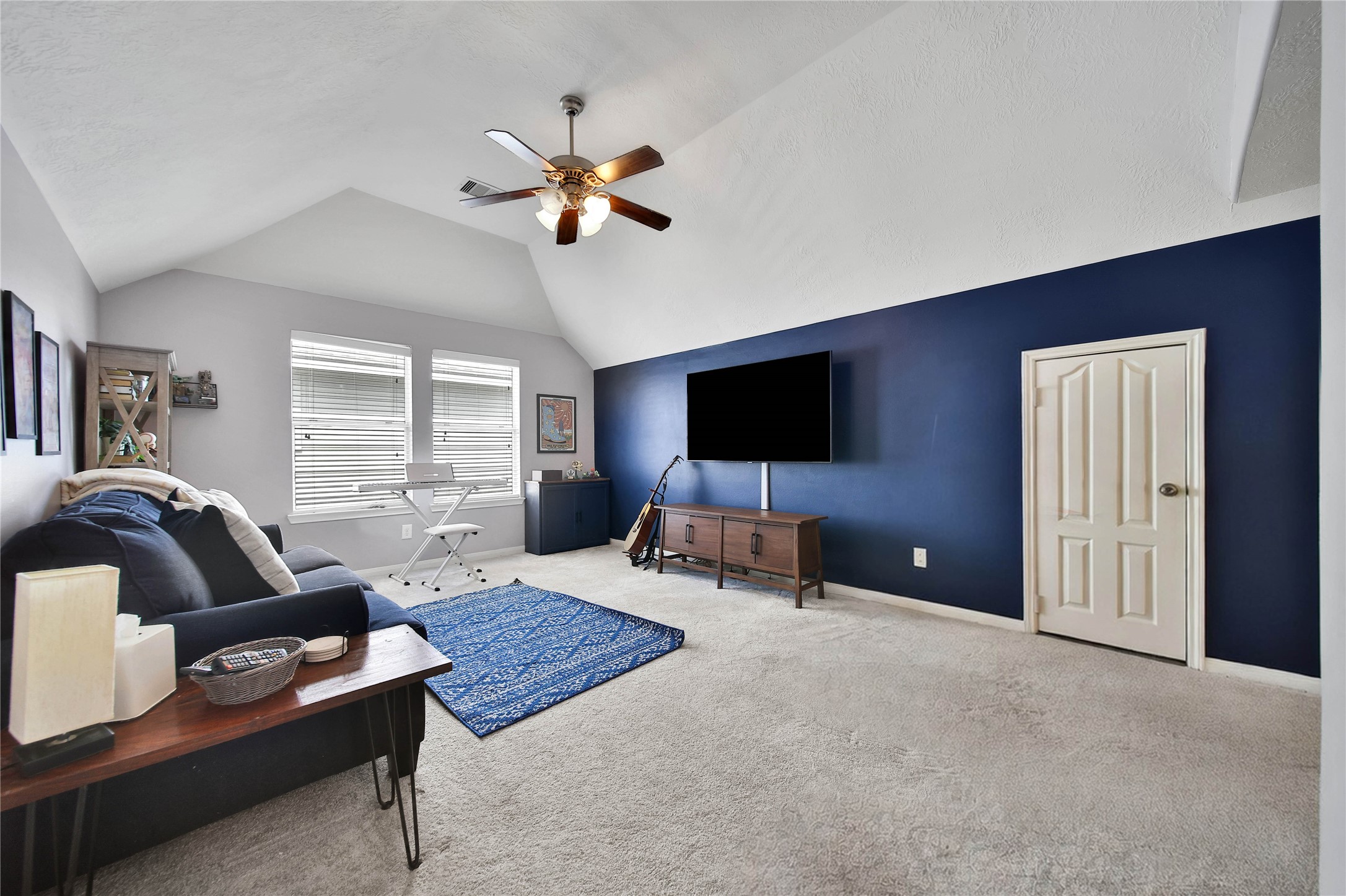 21715 Flecherwood Court Spring, TX 77388 - Photo 23 of 43 a living room with furniture and a flat screen tv