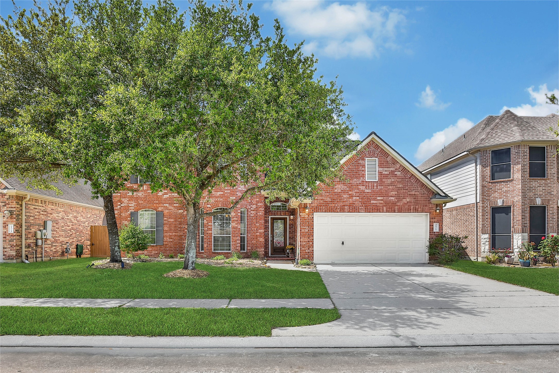 21715 Flecherwood Court Spring, TX 77388 - Photo 4 of 43 a front view of a house with a garden and trees