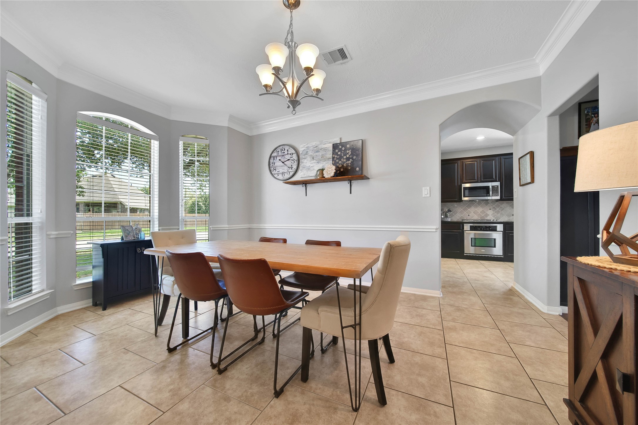 21715 Flecherwood Court Spring, TX 77388 - Photo 8 of 43 a view of a dining room with furniture and a chandelier