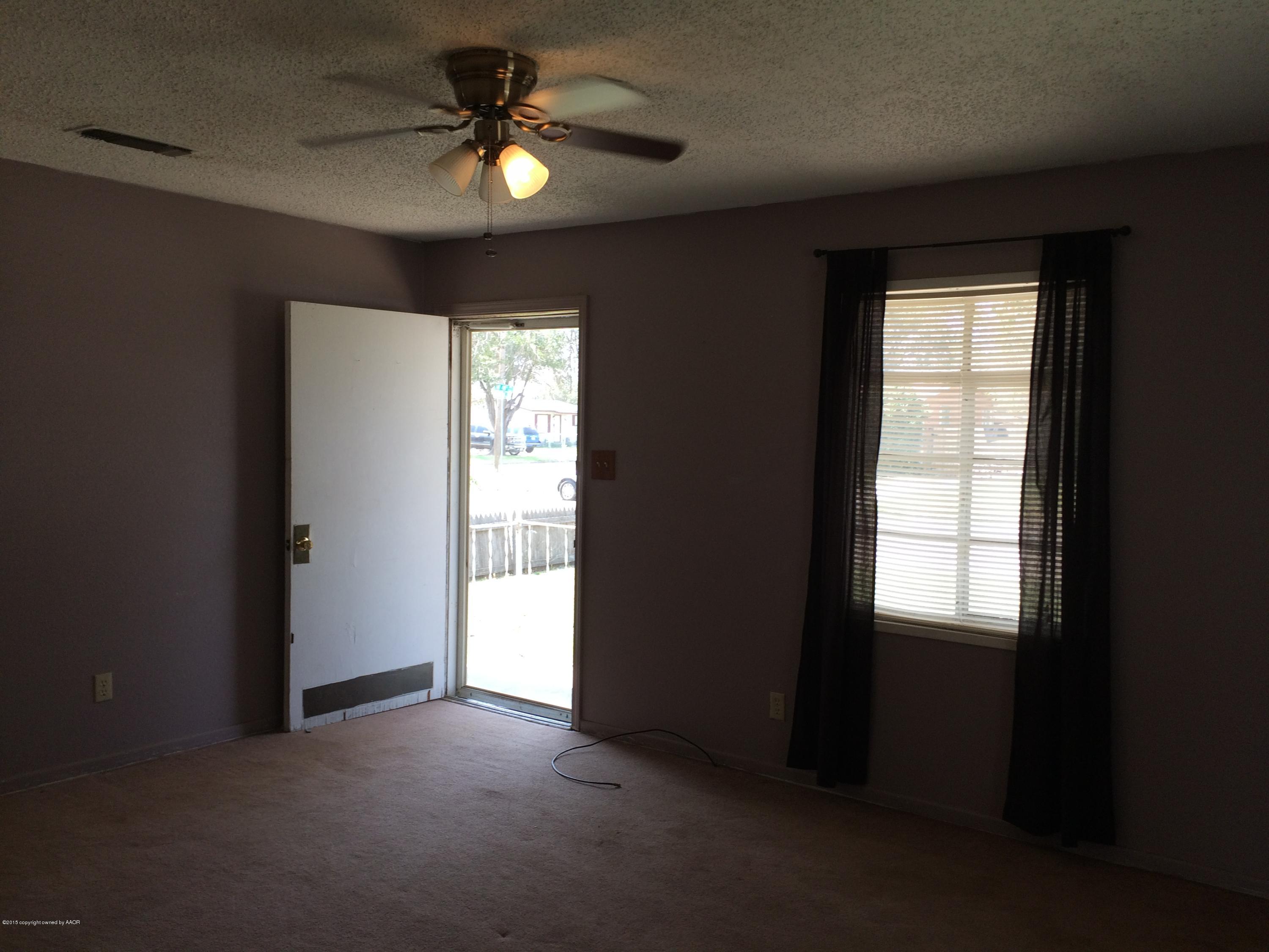 4635 South Hayden Street Amarillo, TX 79110 - Photo 3 of 10 a view of an empty room with a window