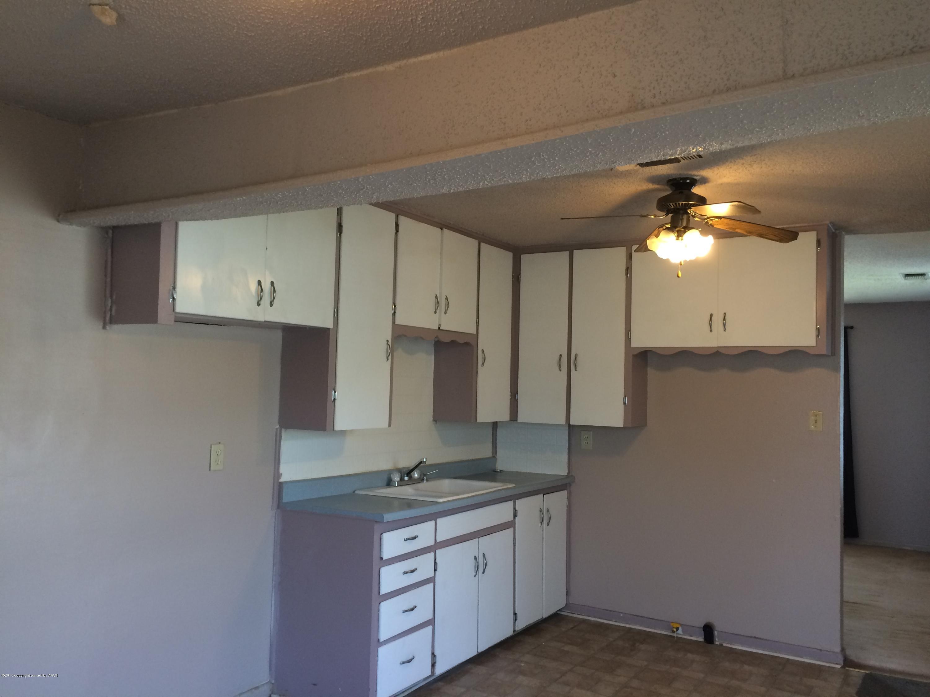 4635 South Hayden Street Amarillo, TX 79110 - Photo 7 of 10 a kitchen with a sink cabinets and appliances