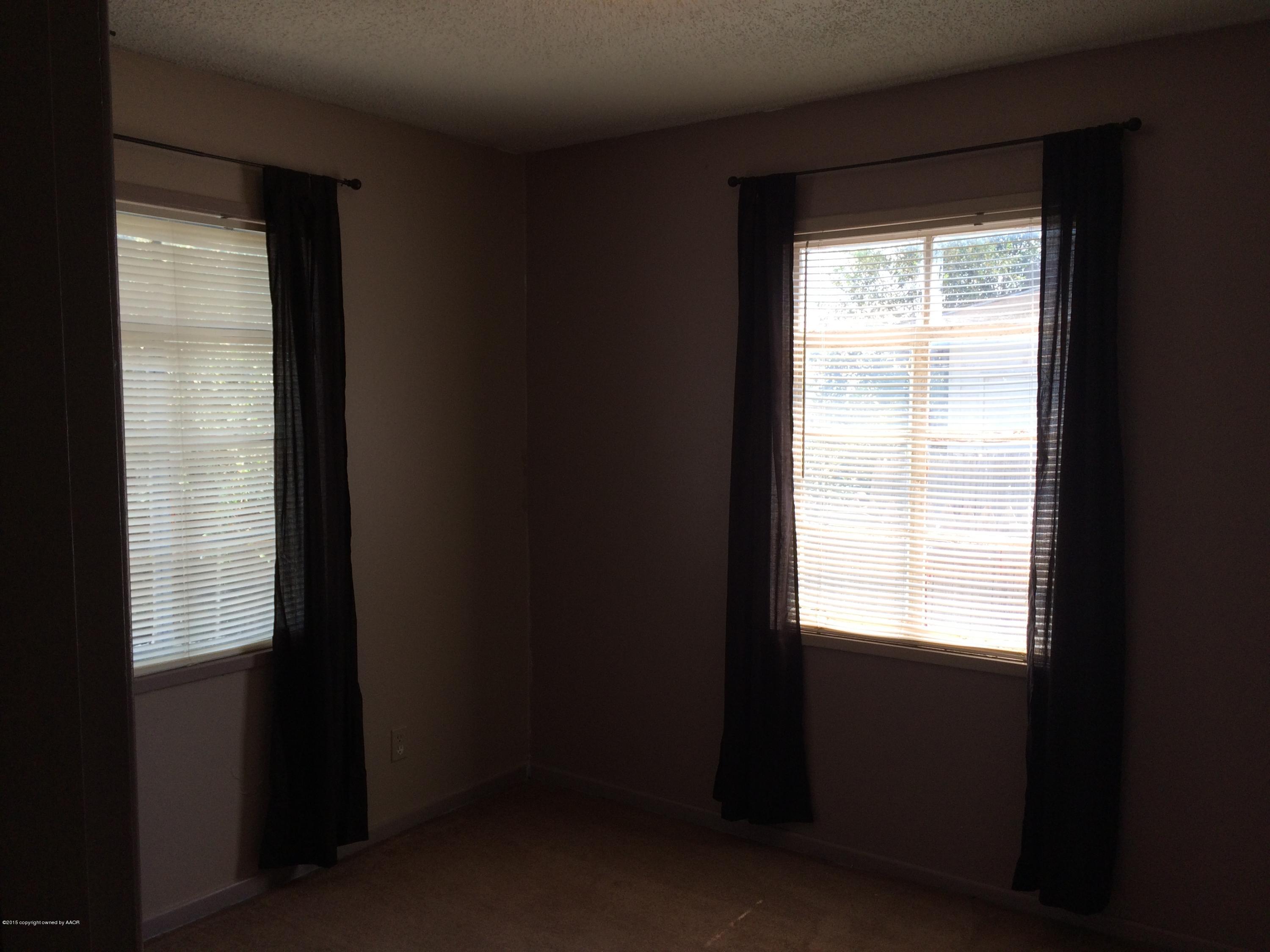 4635 South Hayden Street Amarillo, TX 79110 - Photo 9 of 10 a view of an empty room with a window
