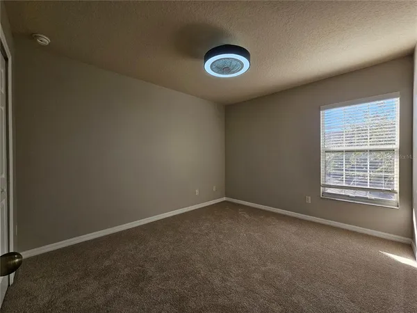 an empty room with a empty space and windows