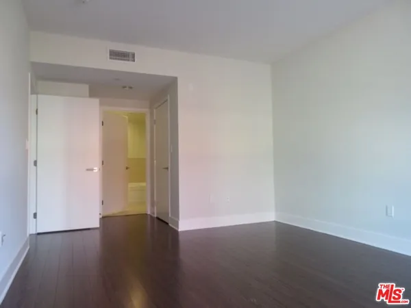 a view of a small space with wooden floor and a window
