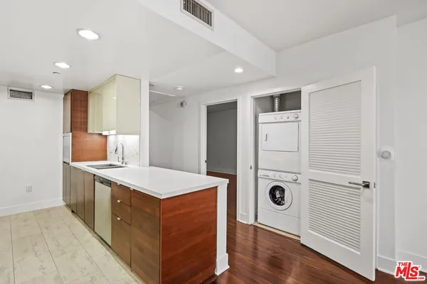 a kitchen with kitchen island cabinets and wooden floor