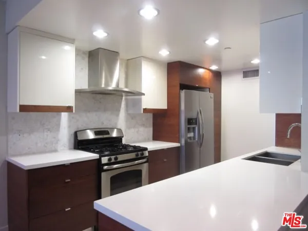 a kitchen with a refrigerator and a sink