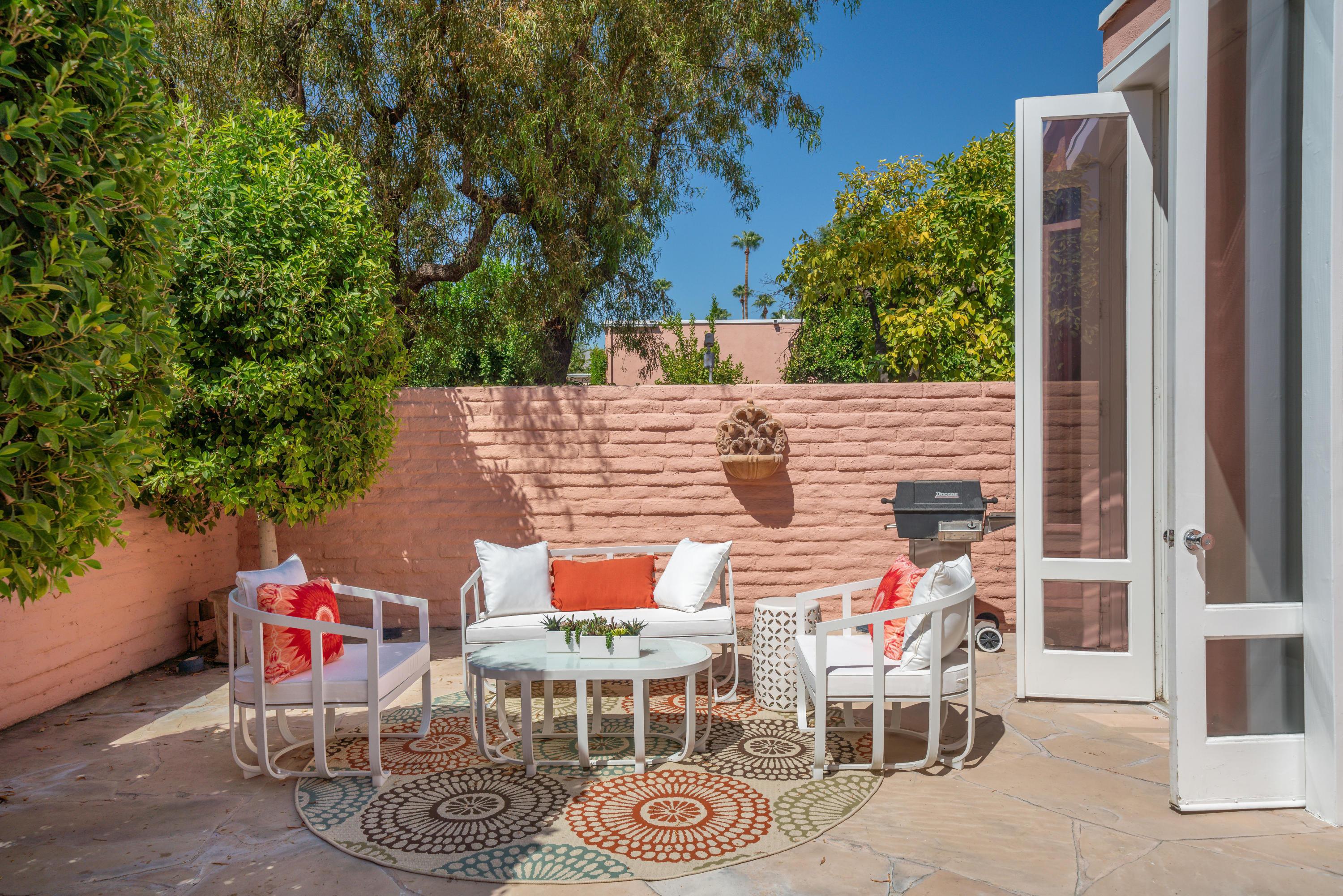 47420 Rabat Drive Palm Desert, CA 92260 - Photo 16 of 50 a view of a patio with table and chairs and potted plants