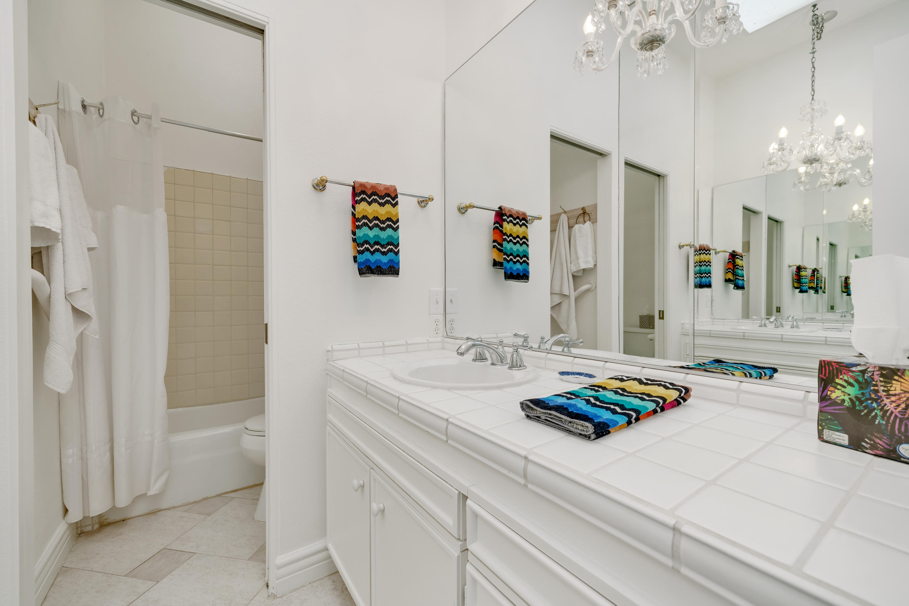 47420 Rabat Drive Palm Desert, CA 92260 - Photo 32 of 50 a bathroom with a sink a vanity a mirror and shower