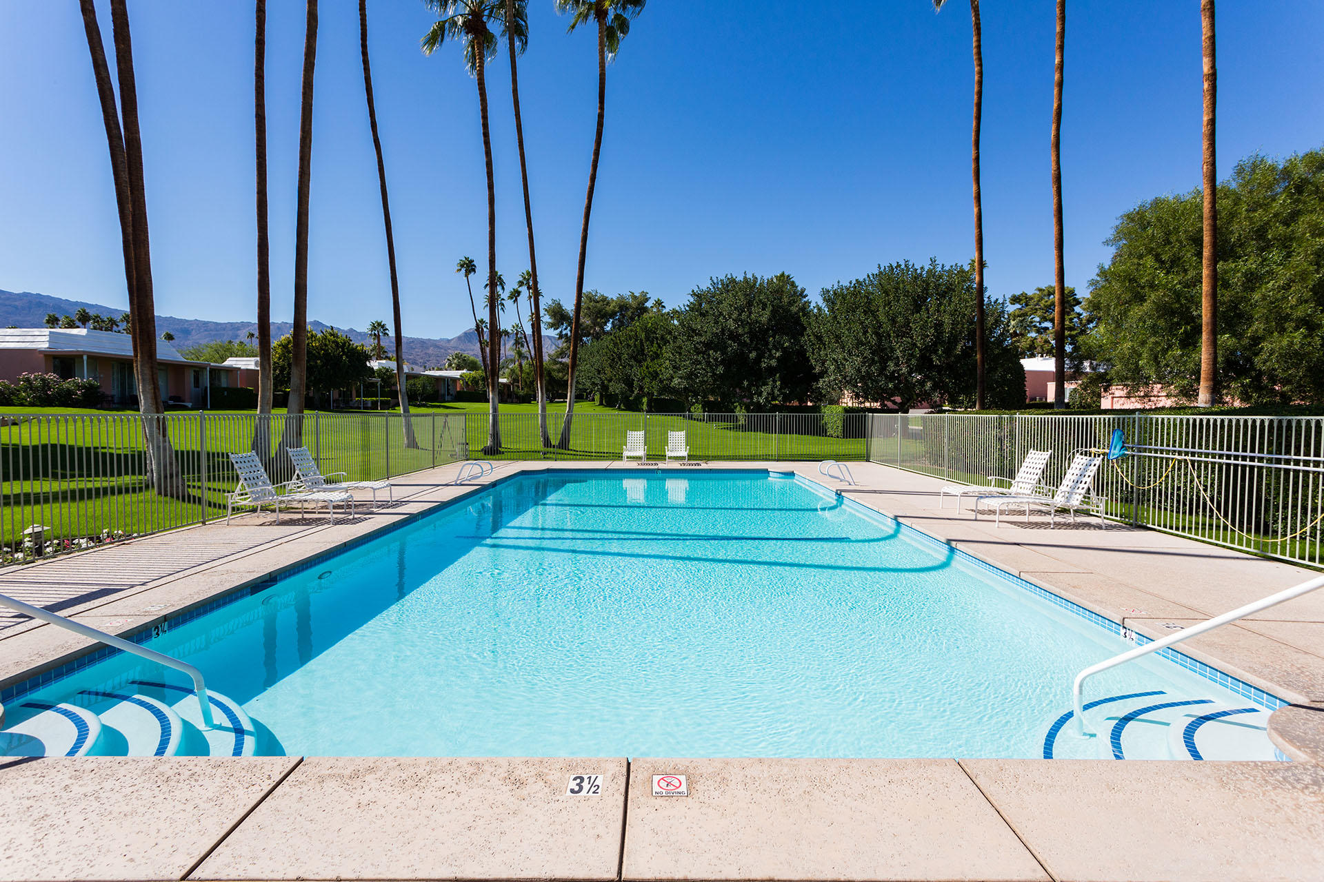47420 Rabat Drive Palm Desert, CA 92260 - Photo 42 of 50 a view of a swimming pool with a lawn chairs