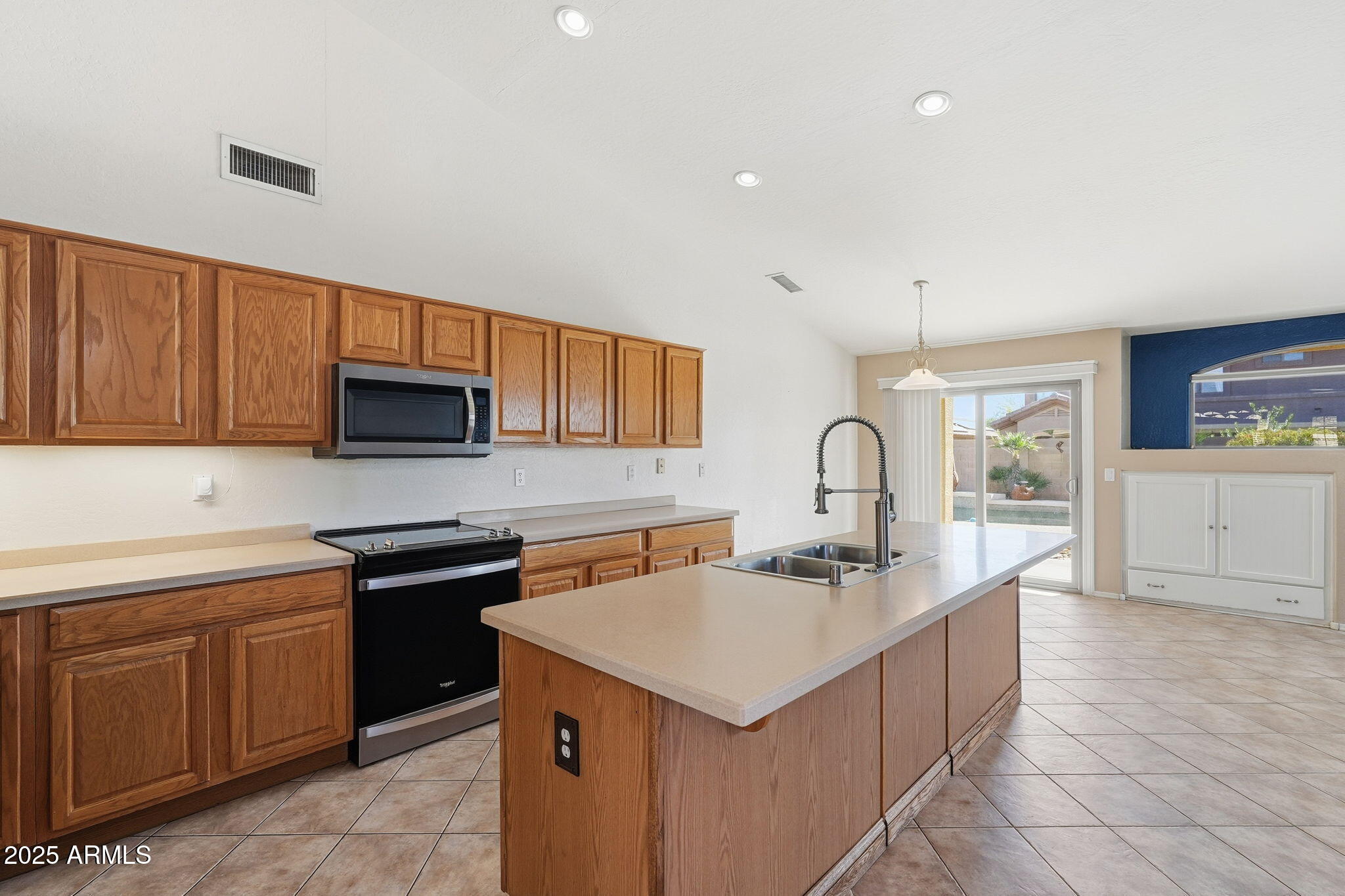 17509 West Rock Ledge Road Goodyear, AZ 85338 - Photo 13 of 55 a kitchen with stainless steel appliances granite countertop a sink stove and cabinets
