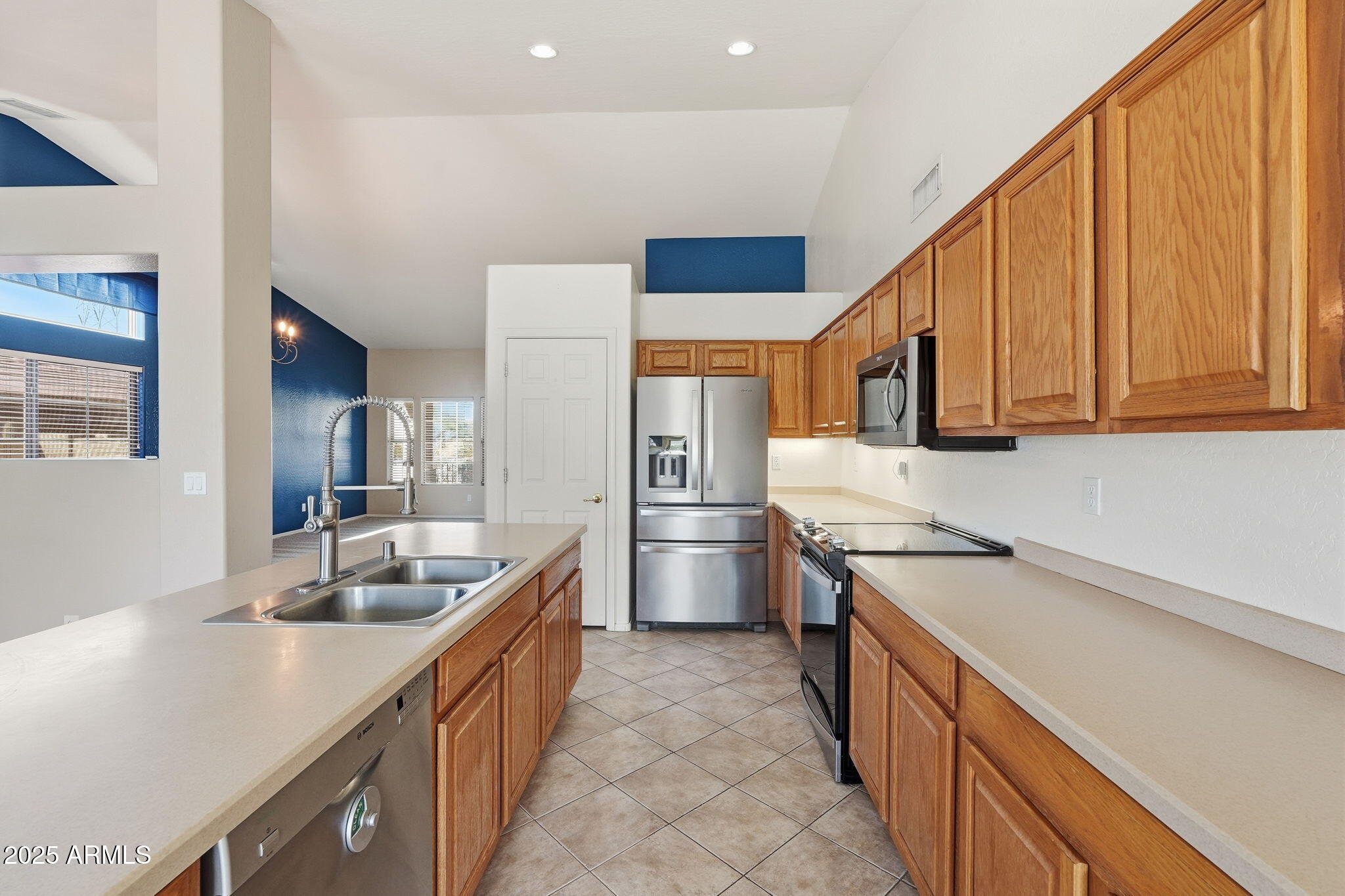 17509 West Rock Ledge Road Goodyear, AZ 85338 - Photo 16 of 55 a kitchen with stainless steel appliances granite countertop a sink and cabinets