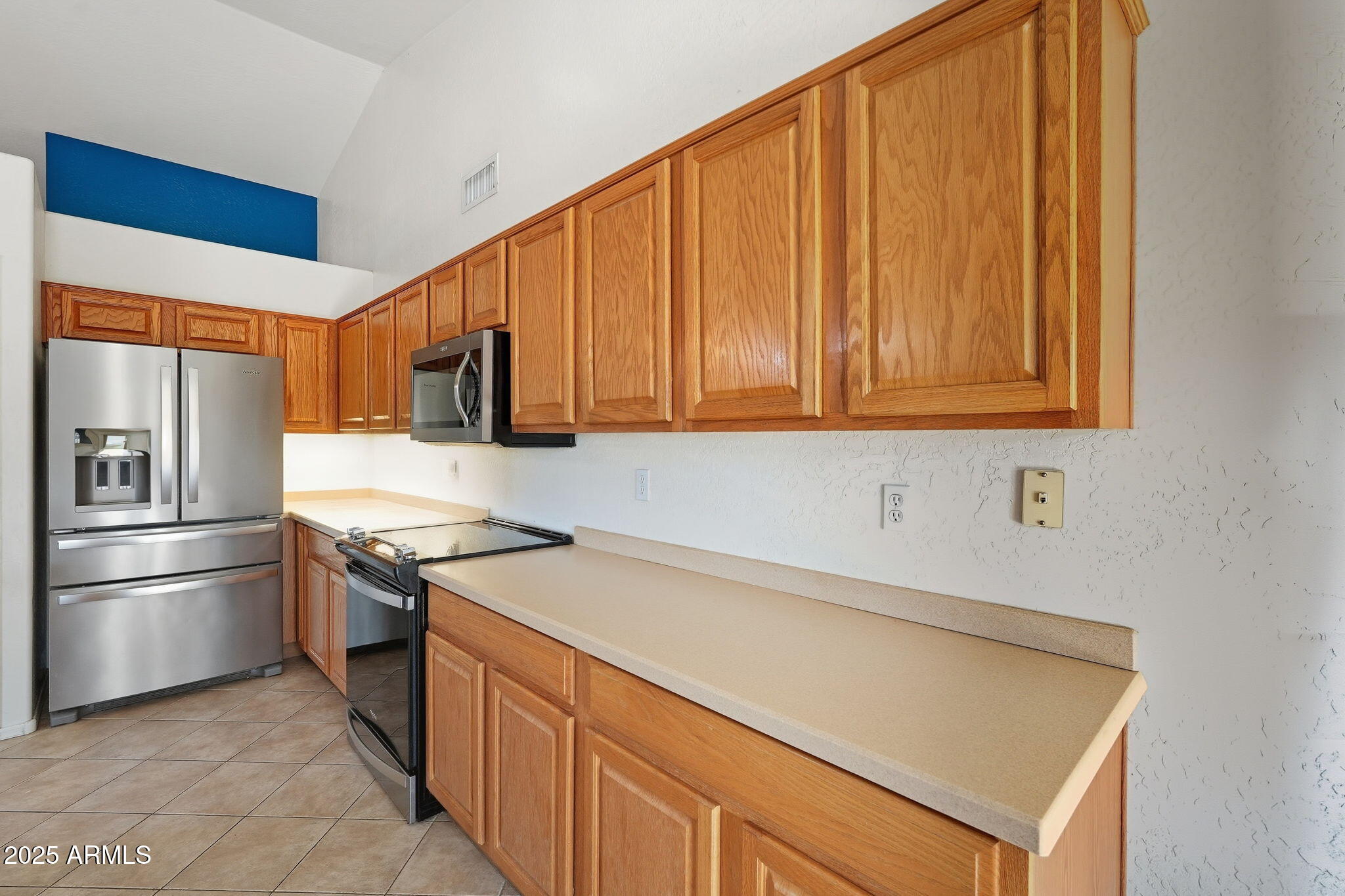 17509 West Rock Ledge Road Goodyear, AZ 85338 - Photo 17 of 55 a kitchen with stainless steel appliances granite countertop a refrigerator a stove and a sink