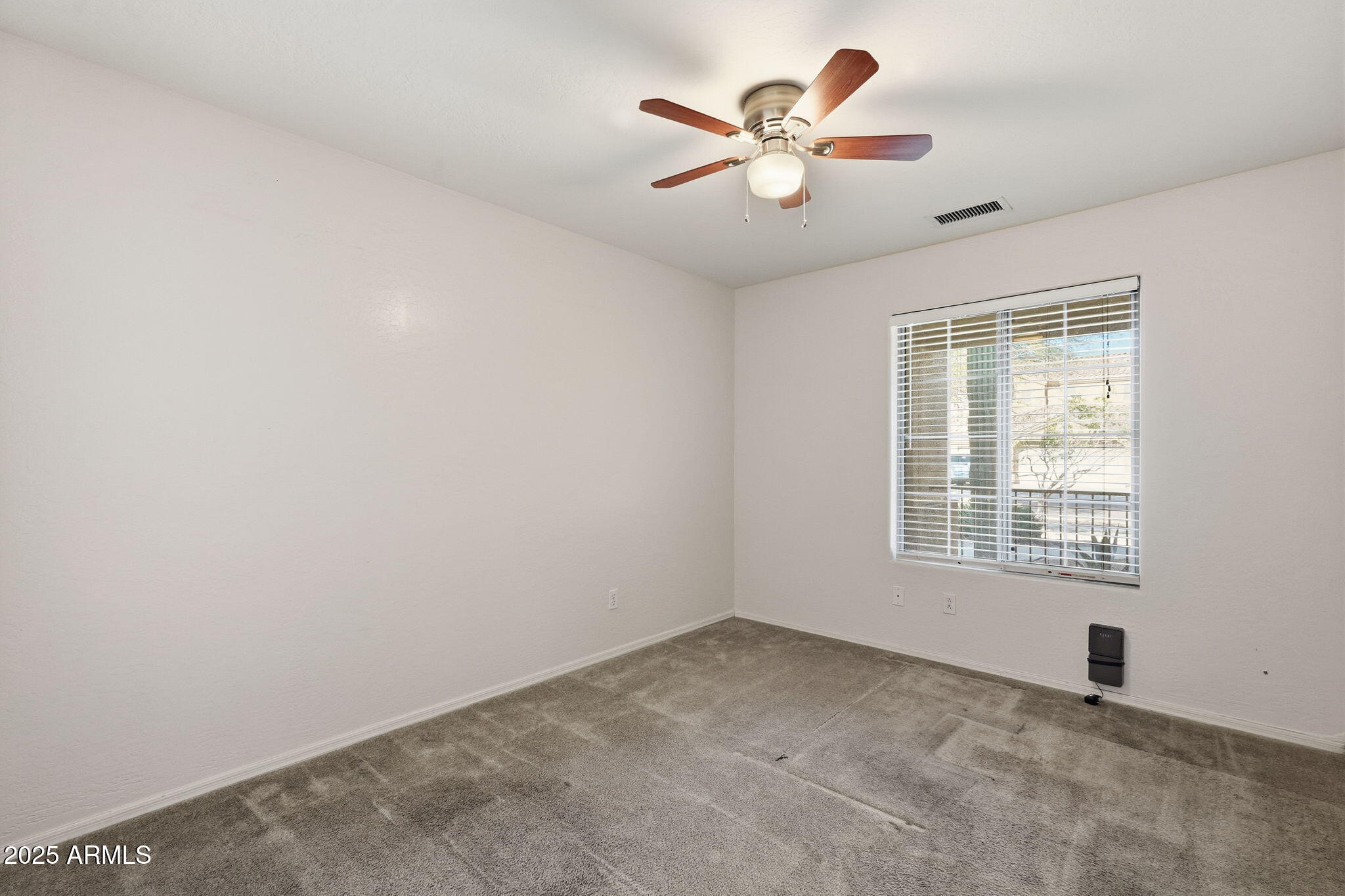 17509 West Rock Ledge Road Goodyear, AZ 85338 - Photo 22 of 55 an empty room with a window