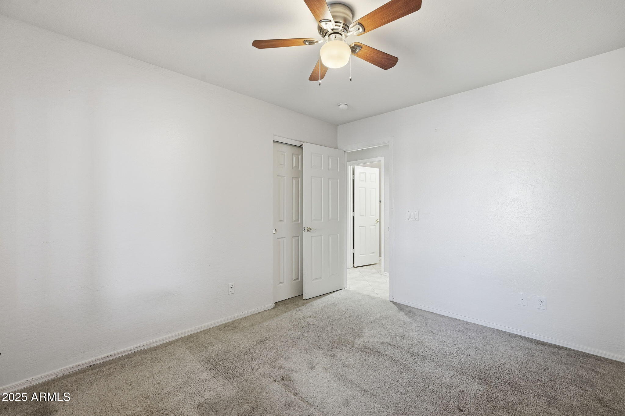 17509 West Rock Ledge Road Goodyear, AZ 85338 - Photo 23 of 55 an empty room with a window and a fan