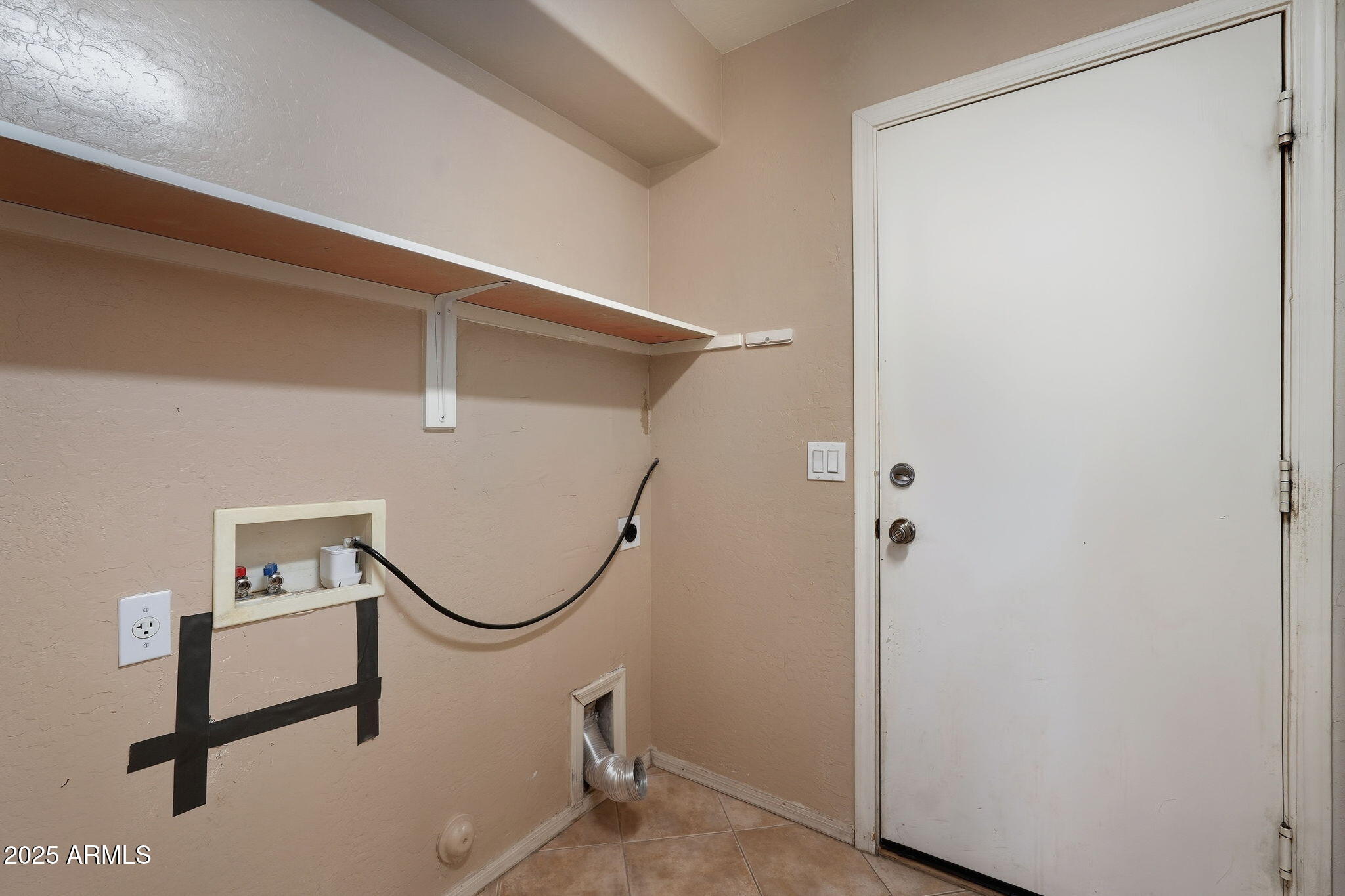 17509 West Rock Ledge Road Goodyear, AZ 85338 - Photo 37 of 55 a room with rack on the wall and a window