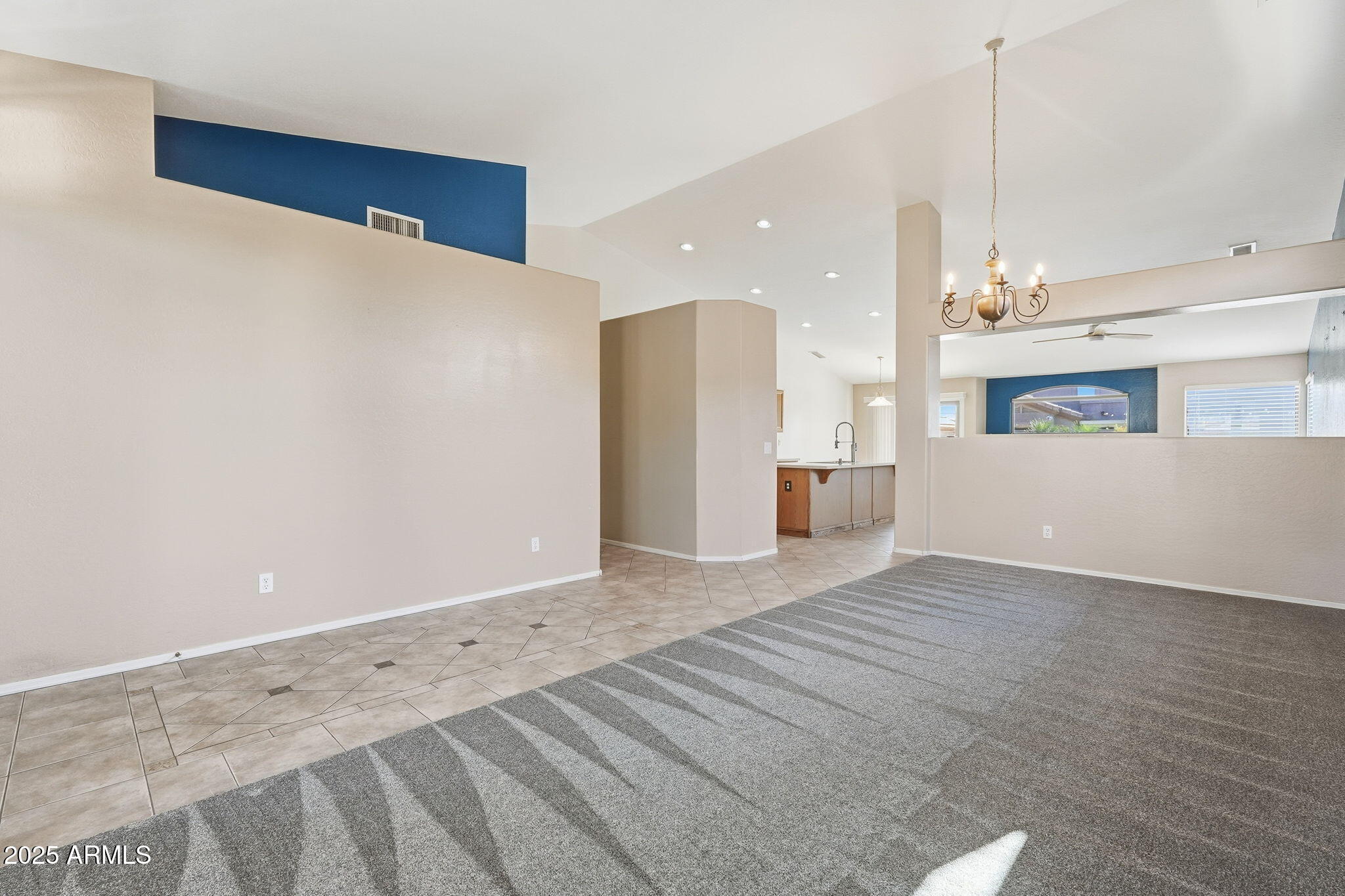 17509 West Rock Ledge Road Goodyear, AZ 85338 - Photo 5 of 55 a view of an empty room with kitchen and a window