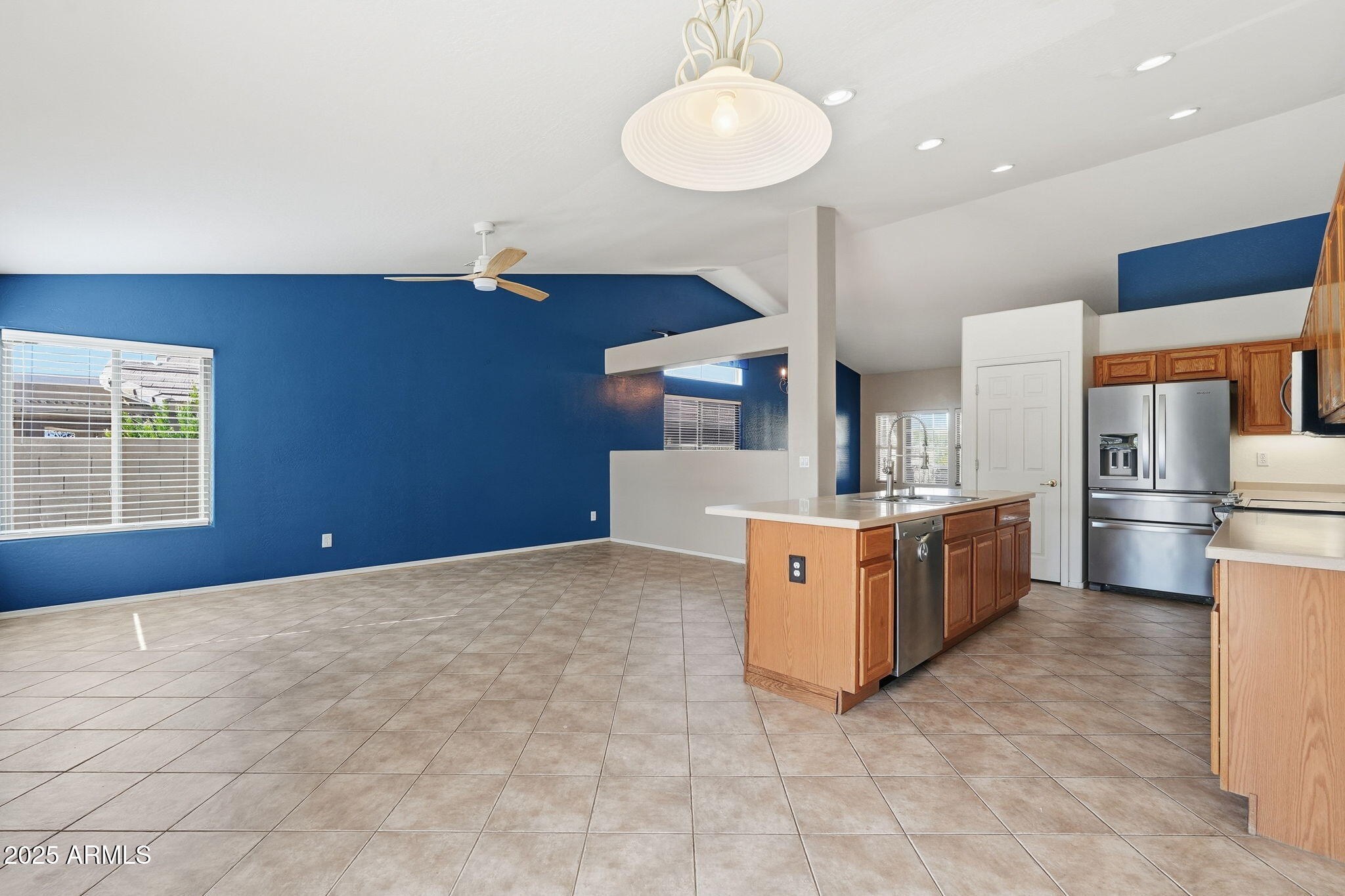 17509 West Rock Ledge Road Goodyear, AZ 85338 - Photo 9 of 55 a kitchen with stainless steel appliances a stove top oven a sink dishwasher and a refrigerator