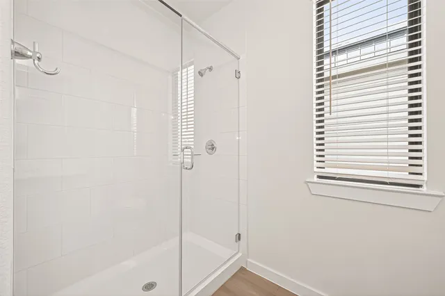 a bathroom with a shower and a window