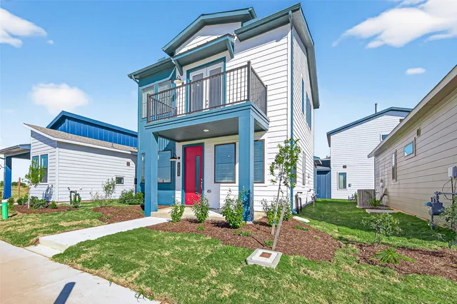 a front view of a house with a yard and porch