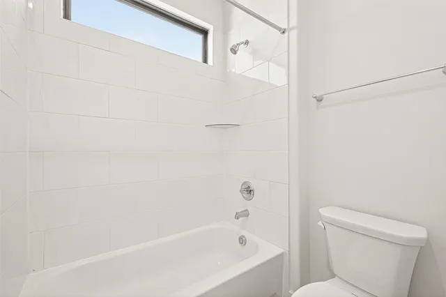 a bathroom with a bathtub and a toilet