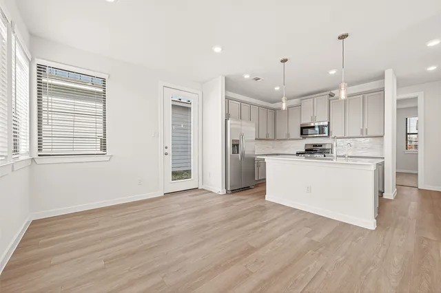 a view of a kitchen with wooden floor