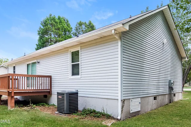 a view of a house with a yard and a porch