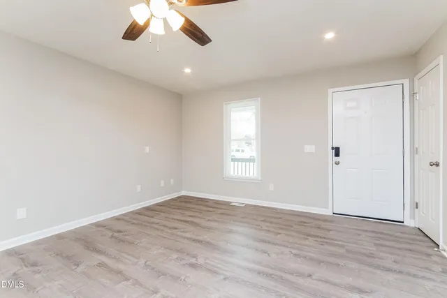 wooden floor in an empty room with a window