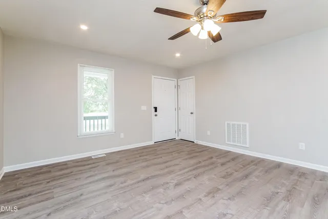 wooden floor in an empty room with a window