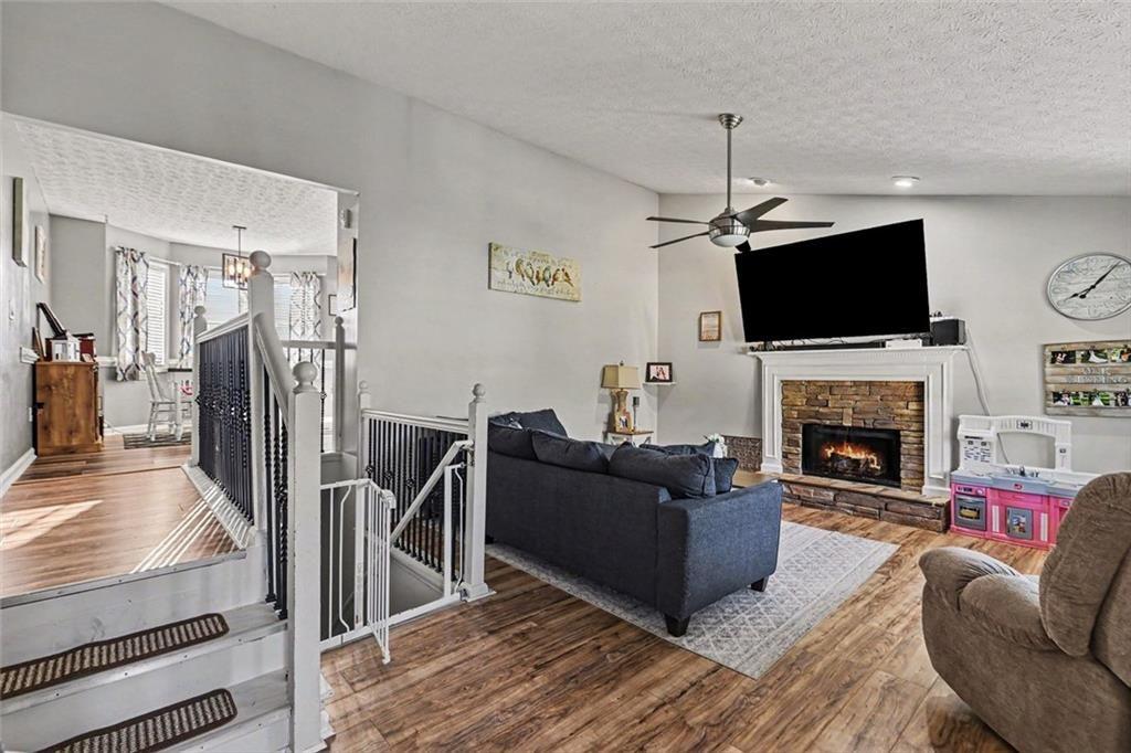 302 Fairview Lane Dallas, GA 30157 - Photo 6 of 26 a living room with furniture a flat screen tv and a fireplace
