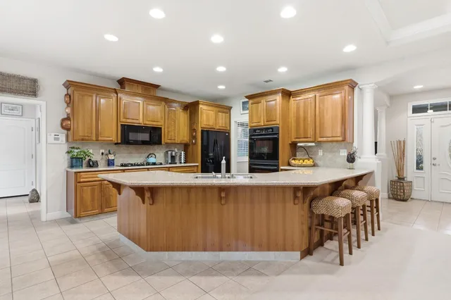 a kitchen with stainless steel appliances granite countertop a stove and cabinets