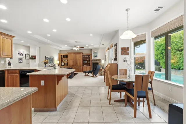 a dining room with furniture a chandelier and wooden floor