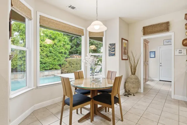a kitchen with stainless steel appliances granite countertop a sink a stove and cabinets