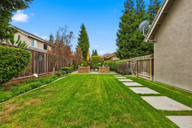 a view of backyard with swimming pool and outdoor seating