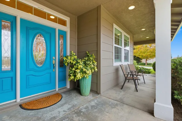 a view of a porch with a table and chairs