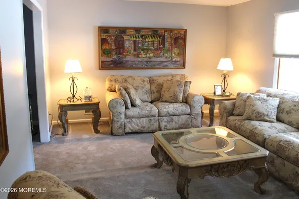 a living room with furniture a window and bookshelf