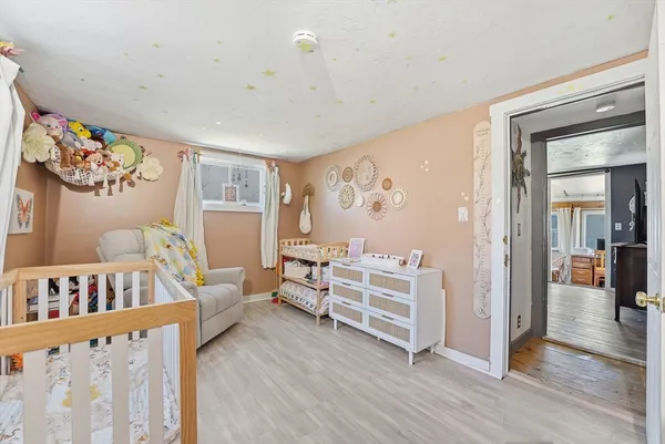 a bedroom with furniture and wooden floor
